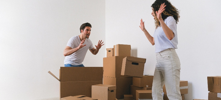 happy couple packing their stuff for the move
