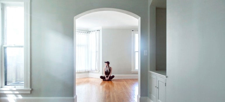 Girl sitting in an empty room