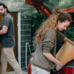 A couple unpacking car while movign to new place