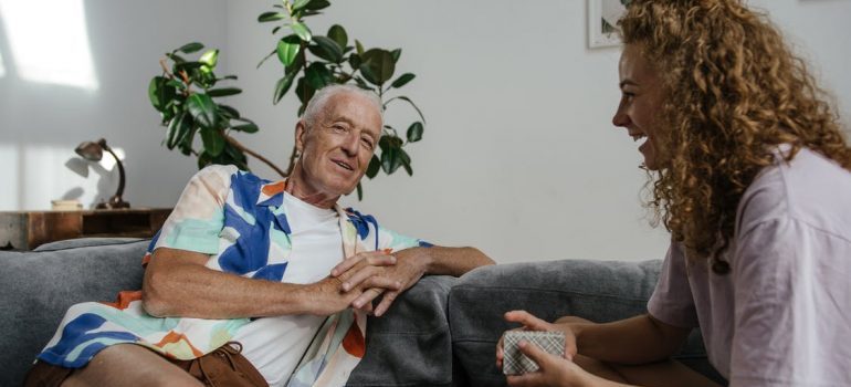 A girl and an elderly person talking about convenient moving services for seniors