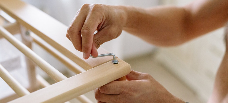 Man assembling a baby cot