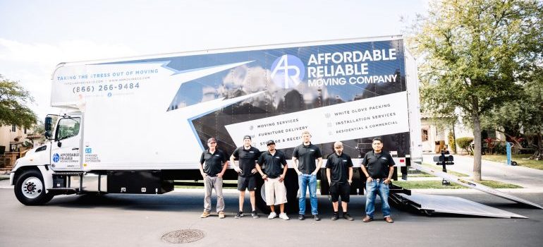 moving truck with the whole movers Newport Beach crew in front