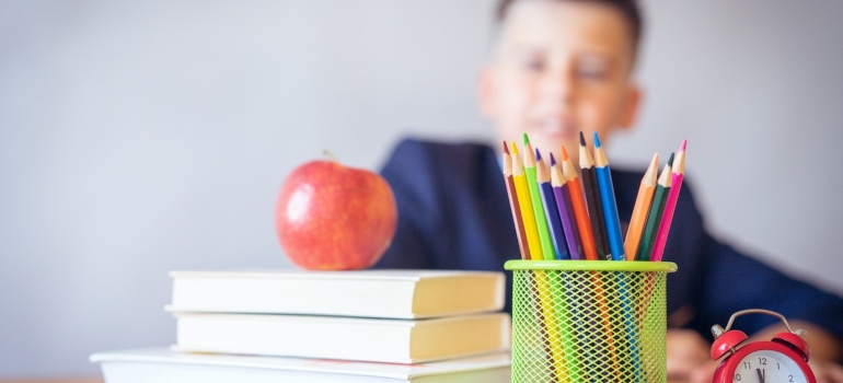 Picture of a kid looking at school supplies