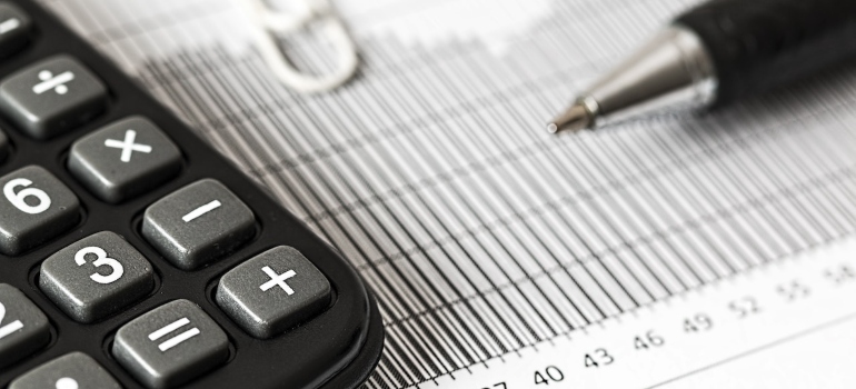 Calculator next to a pen