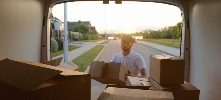 a man unloading boxes out of a truck