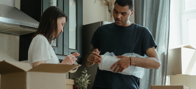 Two people packing for moving