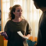Couple talking while moving in new apartment
