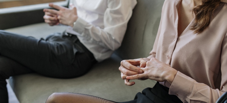 A couple removing their wedding rings after they divorce