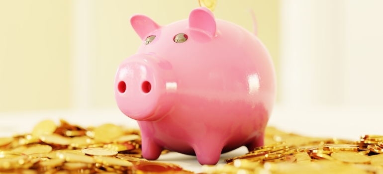 Picture of a piggy bank with saved money for paying the hidden and forgotten costs of moving in OC