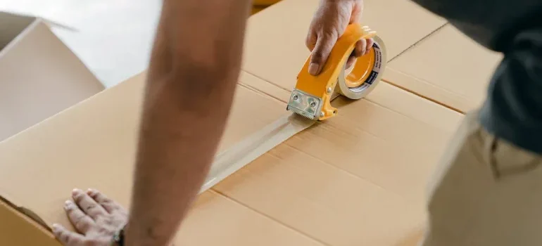 A man closing a box