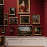 Paintings on a red wall