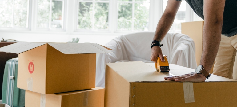 A man learning how to pack artwork