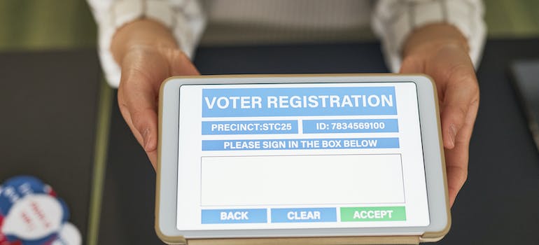 a tablet with a voter registration form on its display