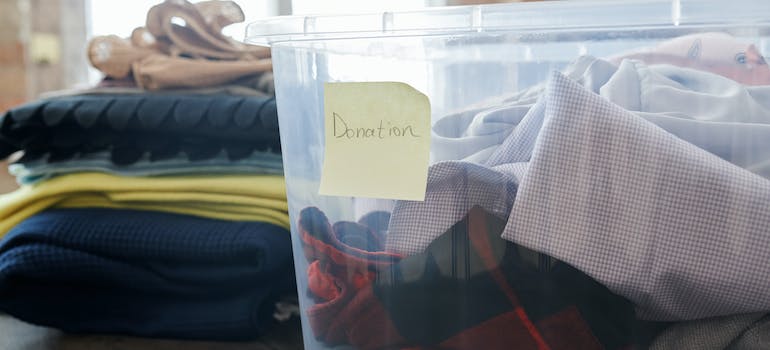 a clear box labeled as containing clothes to be donated