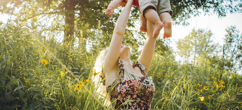 a mother lifting her baby in a carefree manner